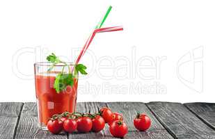 Cherry tomatoes with glass of tomato juice