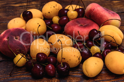 Ripe fruits on dark wooden background