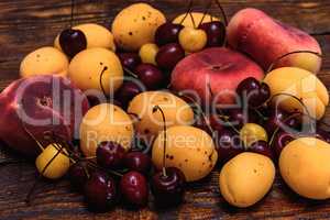 Ripe fruits on dark wooden background