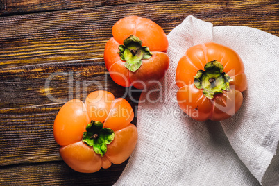 Three Persimmons on Table