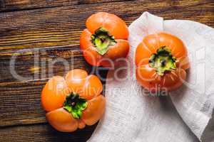 Three Persimmons on Table