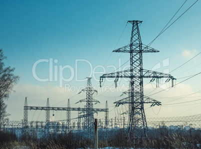 High-voltage overhead power line on blue sky background.