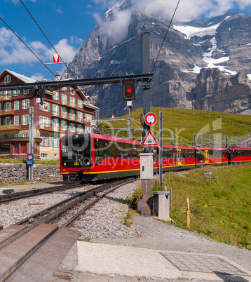 red electric tourist train goes from the station Jungfraujoch top of Europe Kleine Scheidegg, Bernese Oberland, Switzerland, Europe