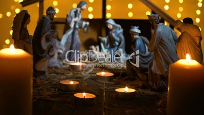 Jesus Christ Nativity scene with atmospheric lights and candles