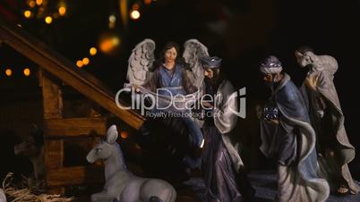 Jesus Christ Nativity scene with atmospheric lights and candles