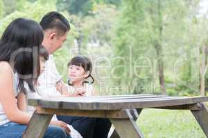 Asian family with empty table space.