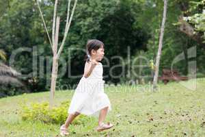 Little Asian girl running outdoors