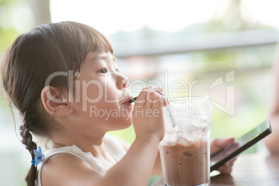 Kid drinking at cafe