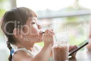 Kid drinking at cafe