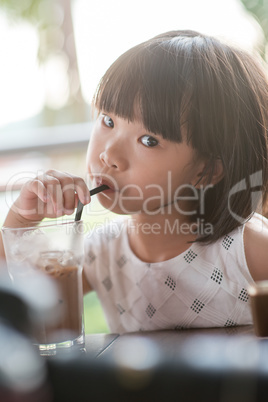 Child drinking at cafe