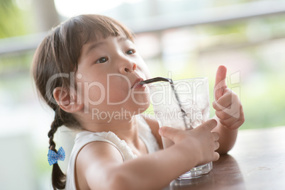 Asian girl drinking at cafe