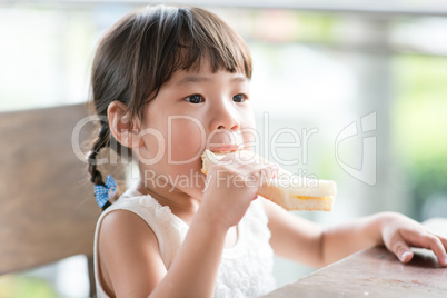 Asian Child eating bread