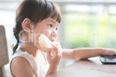 Asian girl eating bread