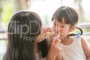 Mom and child sharing bread