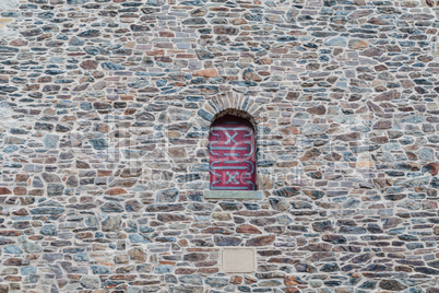 Arch window set in an old stone wall