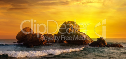 Sea landscape with rocky island and the sunrise. Wide photo.