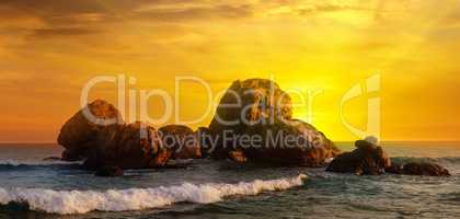 Sea landscape with rocky island and the sunrise. Wide photo.