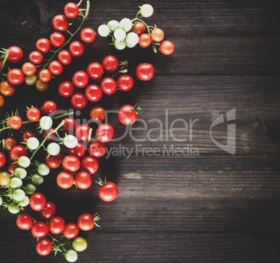 ripe red cherry tomatoes on a brown wooden board