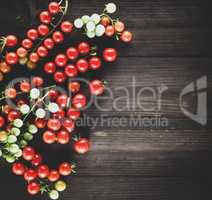 ripe red cherry tomatoes on a brown wooden board