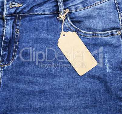 blue jeans with a brown paper empty tag on a rope