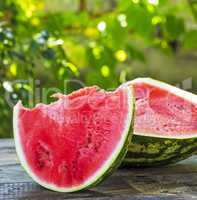 cut a ripe watermelon on a wooden table