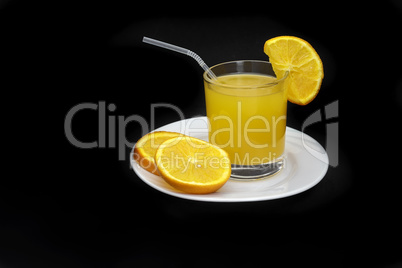 Orange juice in a glass on a black background.