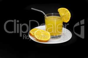 Orange juice in a glass on a black background.