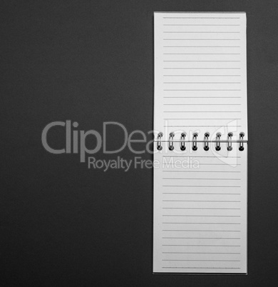 Blank open notebook in a line on a black background
