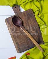 old cutting board with a handle and wooden spoon