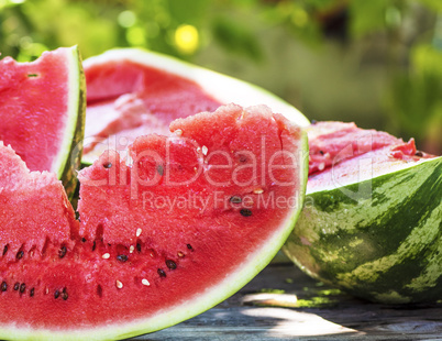 ripe red watermelon with seeds on a wooden table
