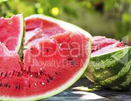 ripe red watermelon with seeds on a wooden table