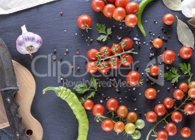 Ripe red cherry tomatoes, chili and spices