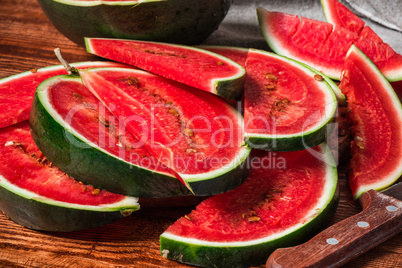 Watermelon slices lying on wooden table