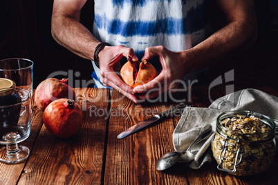 Man Opens Pomegranate.