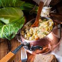 young and fresh cabbage cooked with bacon cubes