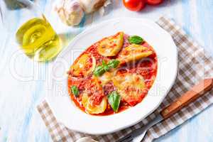 Delicious pasta - ravioli in tomato sauce with basil