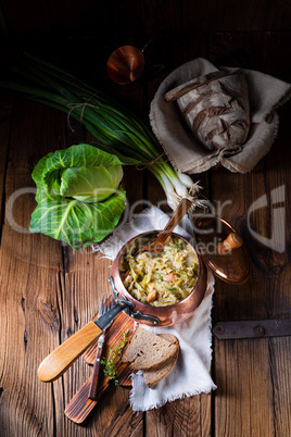 young and fresh cabbage cooked with bacon cubes