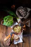 young and fresh cabbage cooked with bacon cubes