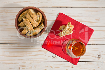 Italian cantucci biscuits and vin santo wine over a red napkin