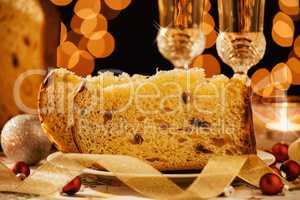 Closeup of sliced italian panettone and sparkling wine