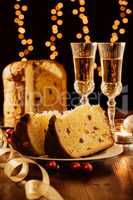 Sliced italian panettone, sparkling wine and decorations