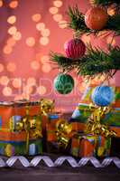 Christmas gifts with blurred lights and ribbon under the tree