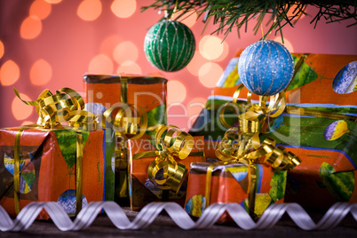 Christmas gifts with blurred lights on background and ribbon und