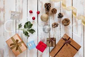 Christmas presents and decorations over a rustic wooden table