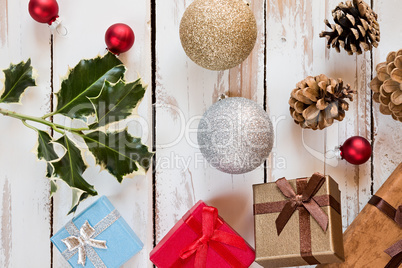 Closeup of Christmas presents and decorations over a rustic wood