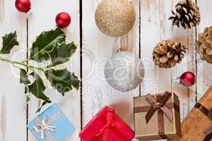 Closeup of Christmas presents and decorations over a rustic wood