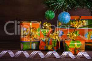 Many Christmas presents under the tree with decorations and ribb