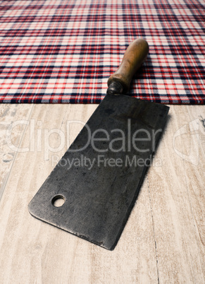Old meat cleaver on a table