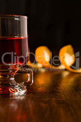 Closeup of alcoholic punch drink and orange peel on background