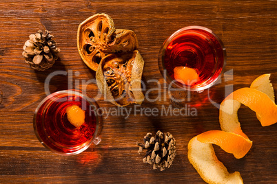 Alcoholic punch drink, dried orange fruit and pine cone